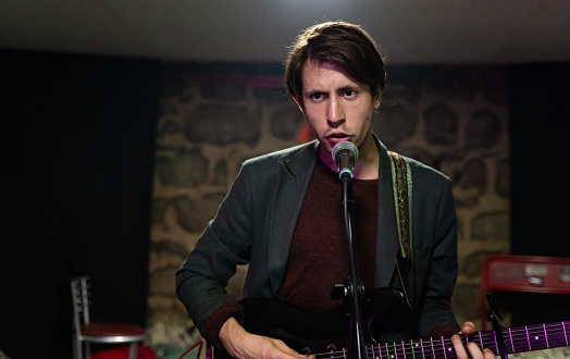 Caucasian ethnicity Young adult man having a music rehearsal in studio