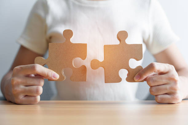 istock Hand connecting couple puzzle piece. Business Solving, mission, challenge, success, goals, target and strategy concepts 1435290127
