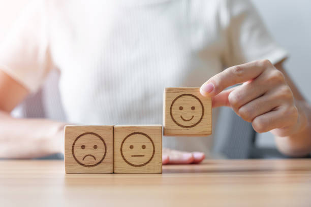 istock Hand choosing smile face from Emotion block for customer review, good experience, positive feedback, satisfaction, survey, evaluation, assessment, mood, world mental health day concept 1435290244