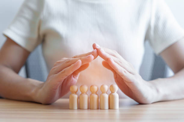 hand cover wood men from crowd of employees. People, Business, Human resource management, Life Insurance, Teamwork and leadership Concepts hand cover wood men from crowd of employees. People, Business, Human resource management, Life Insurance, Teamwork and leadership Concepts together for yes stock pictures, royalty-free photos & images