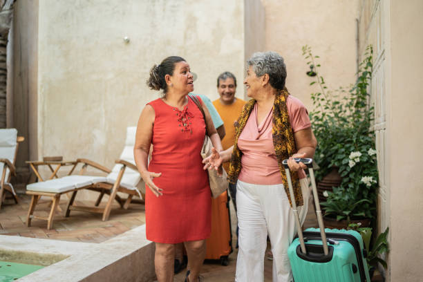 istock Group of senior friends talking while arriving to their accommodation 1435291486