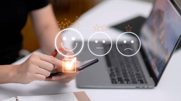 istock Customer service evaluation concept. using a smartphone is pressing face emoticon smiling in satisfaction on virtual touch screen. 1435291585