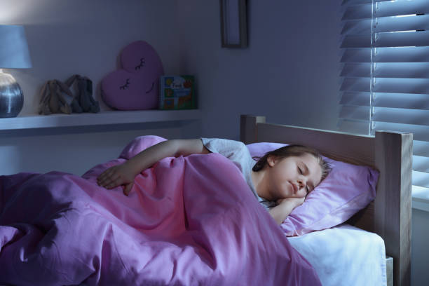 istock Cute little girl sleeping in bed at home 1435292518