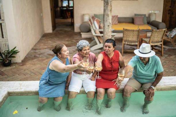 istock Seniors having a toast sitting by the pool 1435292868