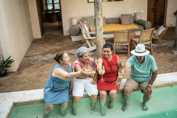 istock Seniors having a toast sitting by the pool 1435292873