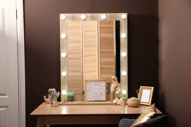 istock Stylish dressing table with mirror near brown wall in room 1435295269