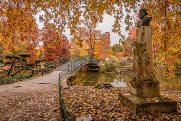 Léon Valade statue and footbridge in the Jardin Public park in Autumn Bordeaux, France