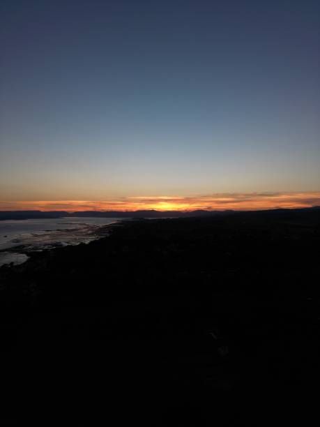 Vertical shot of a bright sunset sky over Helensburgh visible from Dumbarton Castle A vertical shot of a bright sunset sky over Helensburgh visible from Dumbarton Castle dumbarton castle stock pictures, royalty-free photos & images