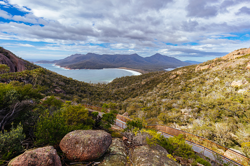 Wineglass Bay from the lookout and walkway on the Freycinet Peninsula Circuit day hike on a warm wet spring day in Freycinet National Park, Tasmania, Australia