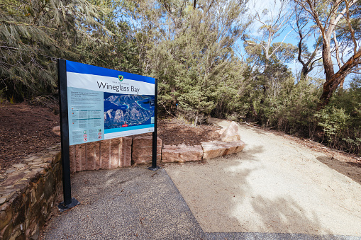 COLES BAY, AUSTRALIA - SEPTEMBER 17 2022: Signage before the Freycinet Peninsula Circuit day hike on a warm wet spring day in Freycinet National Park, Tasmania, Australia