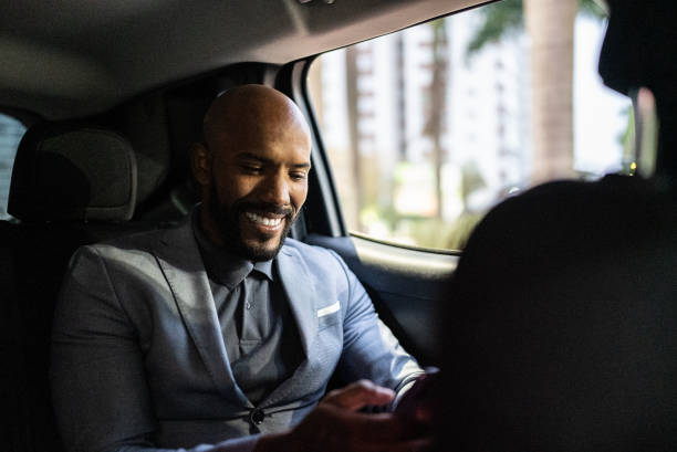 istock Mid adult man using the mobile phone in a car 1435299619
