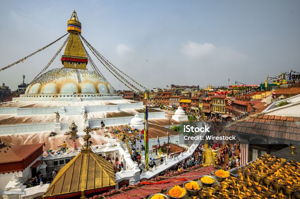 Attractive shot of Boudhanath Stupa temple dome worshipers lighted candles prayer flags Nepal An attractive shot of Boudhanath Stupa temple dome with worshipers lighted candles prayer flags Kathmandu Nepal 2022 Stock Photo