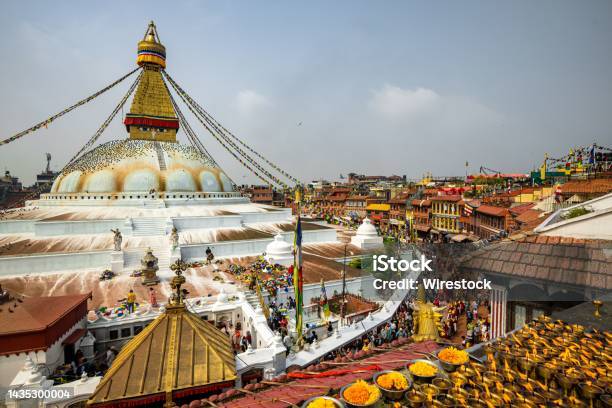 Attractive Shot Of Boudhanath Stupa Temple Dome Worshipers Lighted Candles Prayer Flags Nepal Stock Photo - Download Image Now
