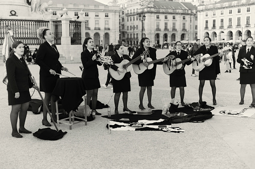 Lisbon, Portugal - February 26, 2022: Female college students perform at the Praça do Comércio square in Lisbon downtown.