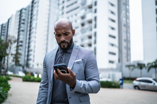 Businessman using the mobile phone outdoors