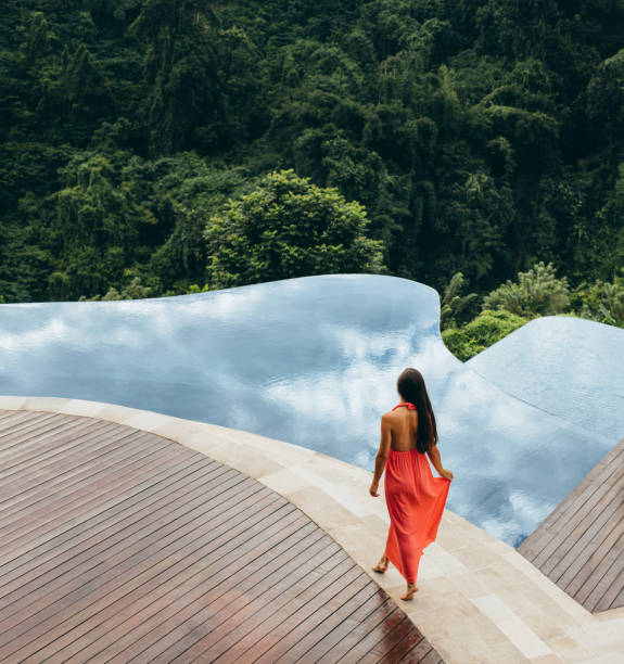Young woman walking at the poolside