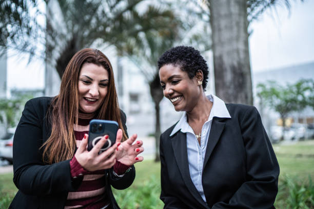 istock Coworkers using the mobile phone outdoors 1435303692
