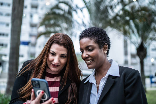 istock Coworkers using the mobile phone outdoors 1435303726