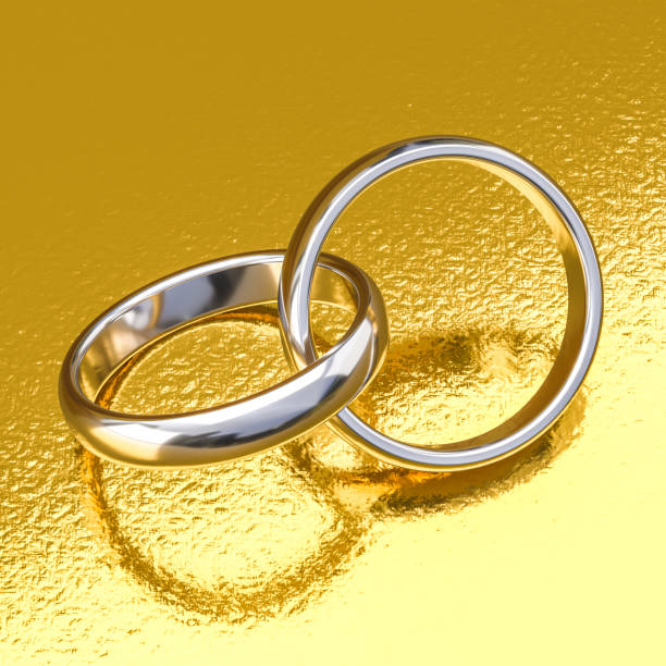 wedding rings in white gold on a gold background. 3d render