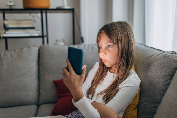 istock Cute girl using phone 1435304690