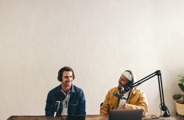 istock Male podcaster interviewing a guest on his show 1435308784