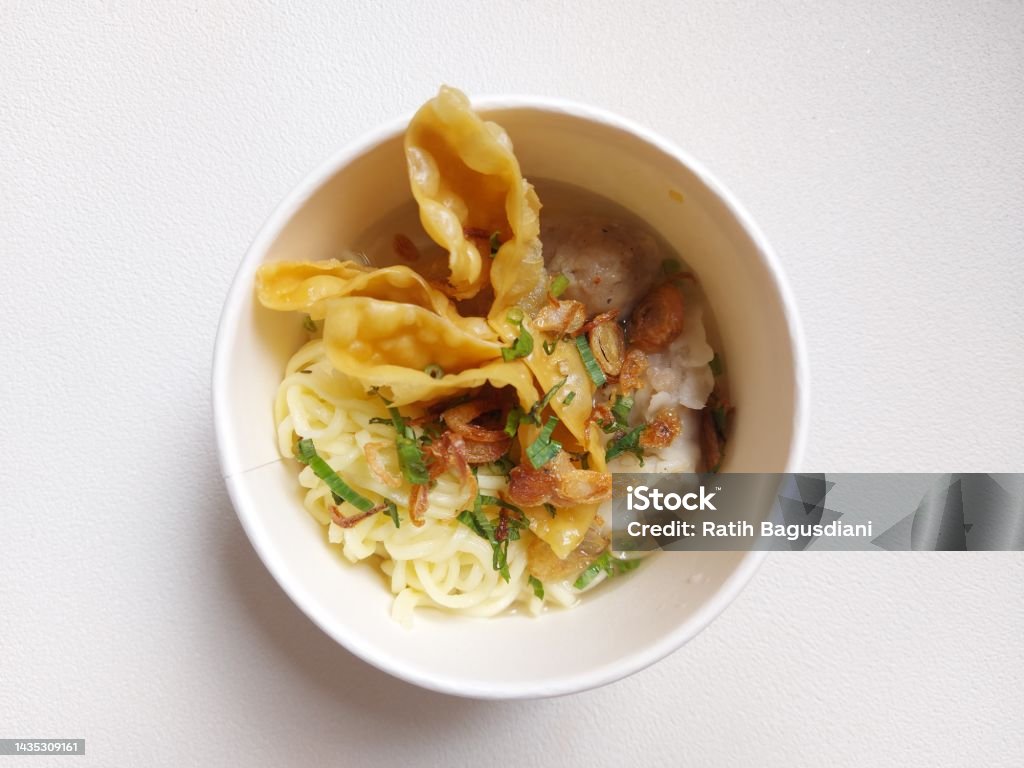 Bakwan malang on a bowl Bakwan malang on a bowl. It is authentic food from malang city,indonesia. Concist of  noodle, fried meat, tofu, and meatballs. Isolated background in white Asia Stock Photo
