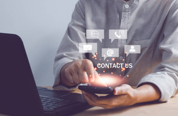 istock Communication and Contact us or Customer support hotline people connect. women holding using a smartphone and touching on virtual screen contact icons, email and address, live chat with internet wifi. 1435310778