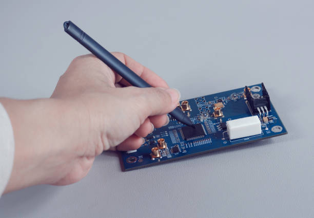 istock men hold tool repairs electronics manufacturing Services, Manual Assembly of Circuit Board. 1435310790