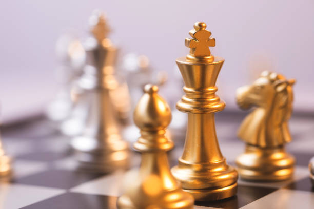 istock silver and gold chess are facing each other, business management ideas strategize to conquer opponents. 1435311905