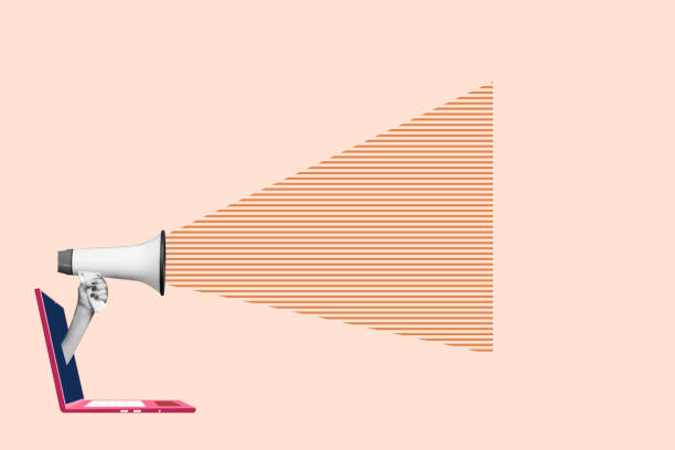 istock hand with megaphone out of laptop screen and shouting. 1435312451