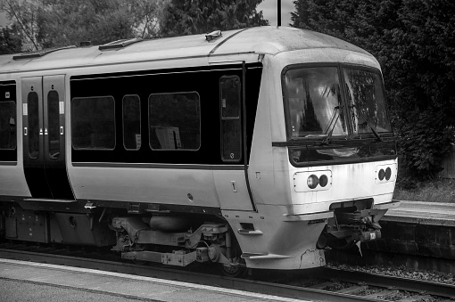 A station England UK. Diesel powered railway line in the English countryside. Station on a sunny day.