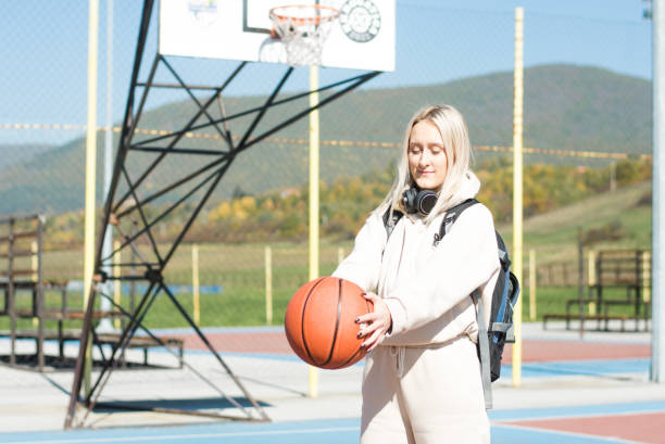 istock Young woman with a basketball 1435314099