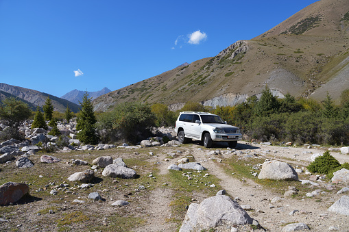 Issyk-Kul, Kyrgyzstan - Sept 19, 2022: Off-road car shown in Grigorievskoe gorge, Kyrgyzstan. Extreme mountain safari is one of the main local tourist attractions in Kyrgyzstan