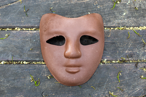 brown carnival mask on wooden background