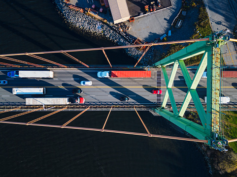 Looking down on traffic crossing a suspension bridge.