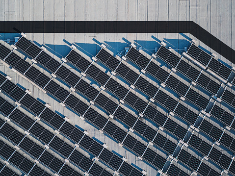 Drone view of rooftop solar panels installed on a municipal (government) city maintenance garage.
