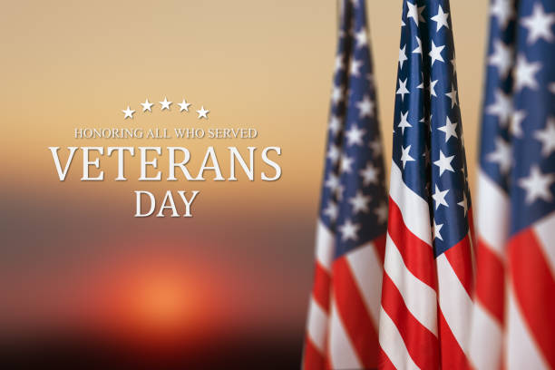 istock American flags with Text Veterans Day Honoring All Who Served on sunset background. 1435320787