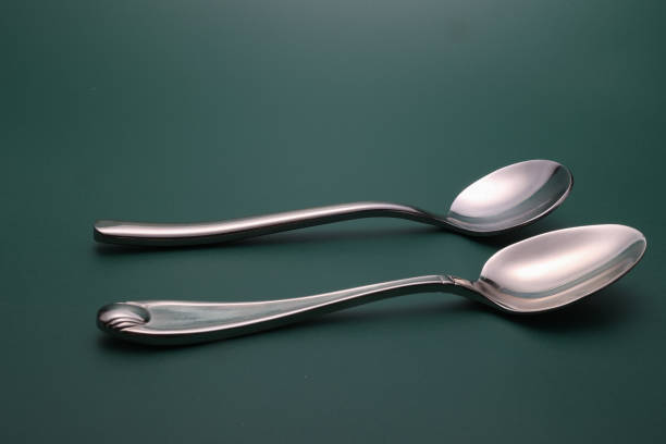 Silver Spoon on dark background Dark  Spoon baby spoon stock pictures, royalty-free photos & images