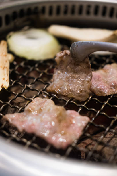istock Grilling sliced beef over stove. 1435321023