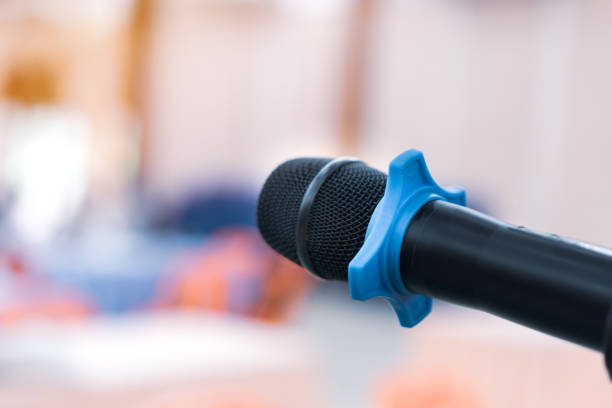 istock Public Microphone for speaking blure backgrounds, Close-up  microphone on stand for speaker speech in seminar room with Event light convention hall for Business meeting and Education 1435321227
