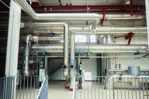 Pipes running through a large industrial power station using water to provide heat for homes