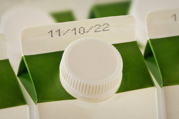 Close-up of milk cartons with expiration date stock photo
