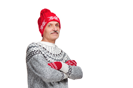Senior man wearing red winter hat isolated on white