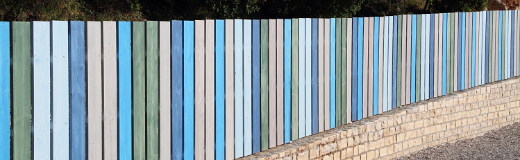 a colorful new wooden fence