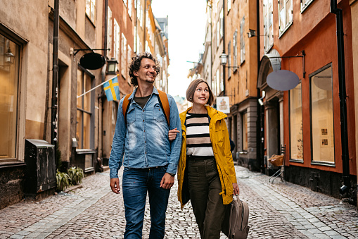 Beautiful young couple walking through the city in Stockholm, Sweden.