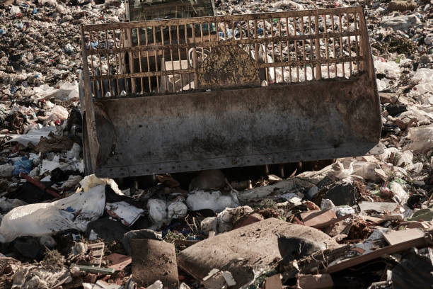 istock Heavy machinery shredding garbage in an open air landfill. Pullution 1435328681