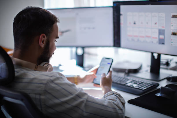 Computer programmer testing a new software program. stock photo