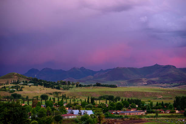 A view of the mountains under a stormy sky  in Clarens, South Africa A view of the mountains under a stormy purple sky at sunset in Clarens, South Africa. The popular town is near the Golden Gate Highlands National Park, which is part of the Drakensberg range. golden gate highlands national park stock pictures, royalty-free photos & images