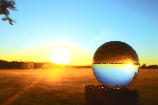 Photo of a crystal ball at Sunset by the Tagus River in Lisbon downtown.