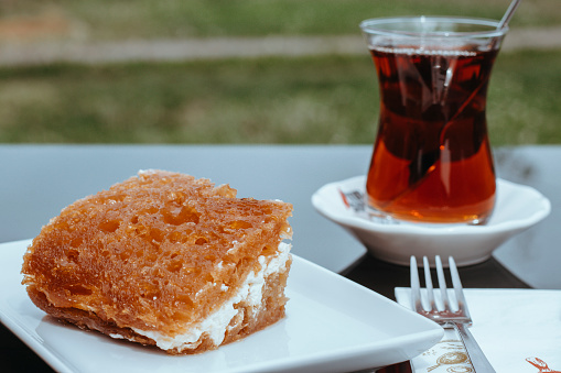Traditional Turkish Tea and bread kadayıf, bread kadayıf and tea, snacks in the cafe, tea and dessert for one person